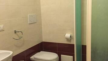 A bathroom with a toilet, bidet, and sink.