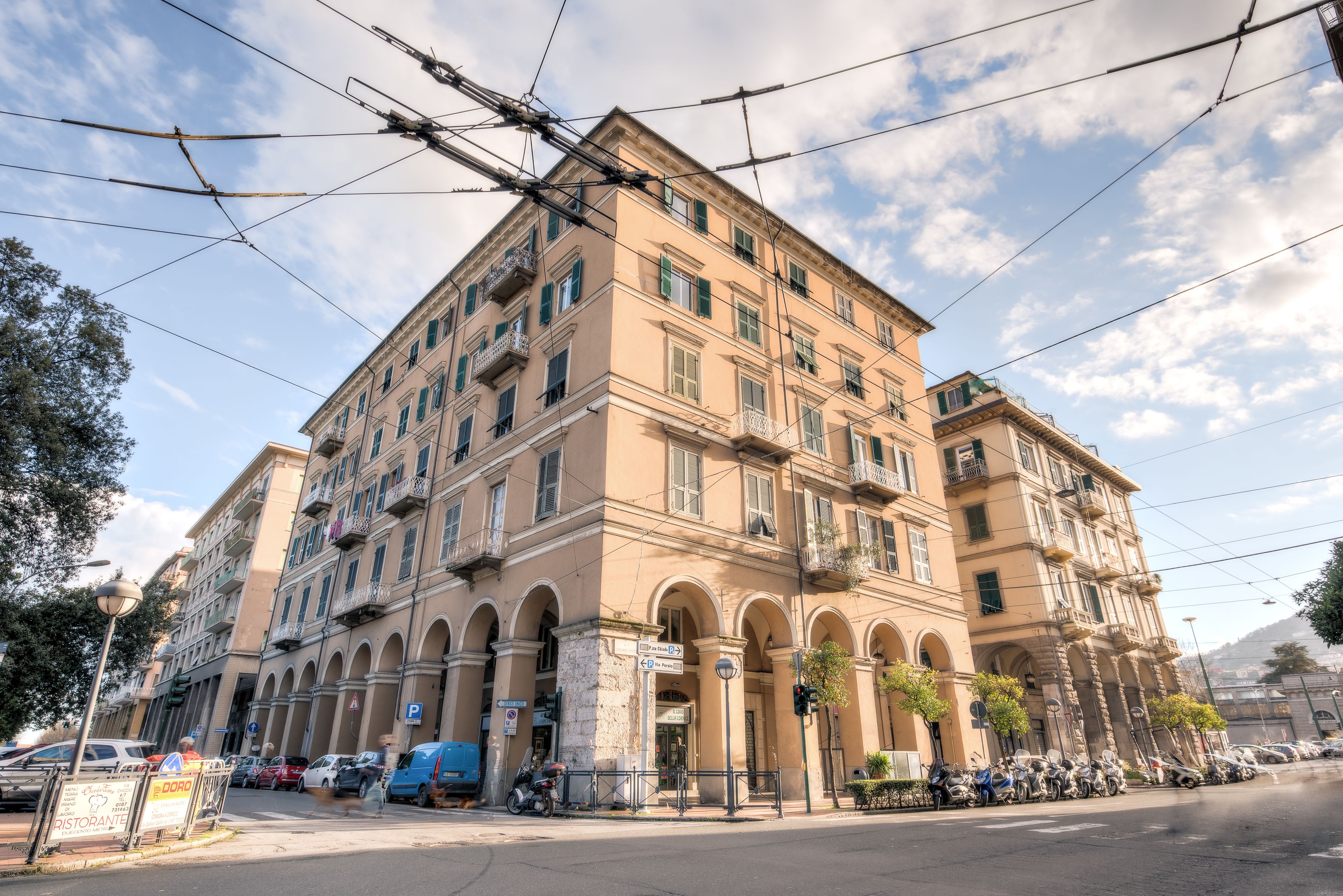 A multi-story building with a classic architectural style, featuring arched windows and balconies.