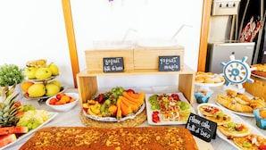 A buffet table with various food items including fruits, yogurt, and pastries. - Hotel Kim (Rimini)