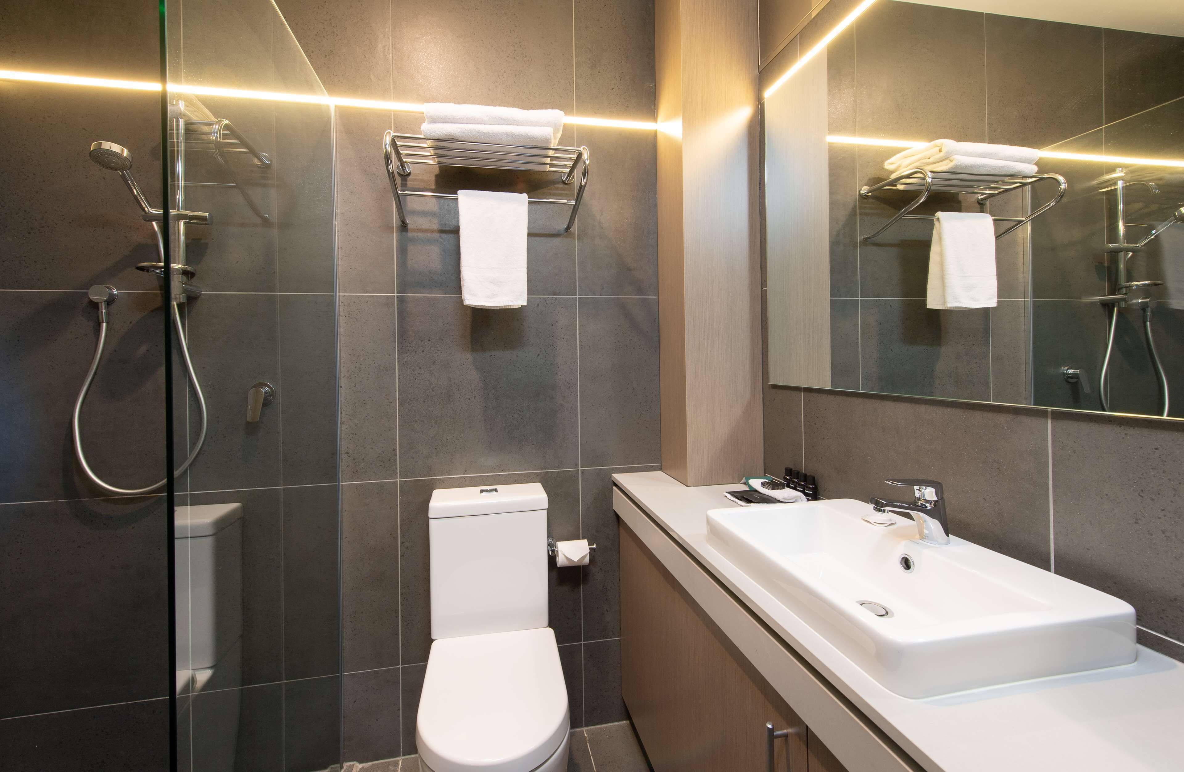 shower, designer toiletries, hair dryer, towels