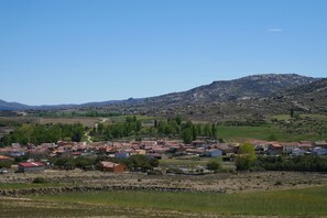 A rural village with houses and a mountain in the background.