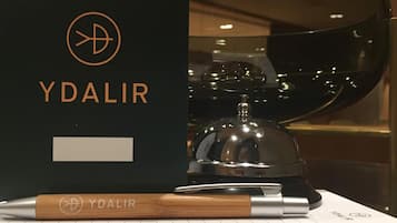 A black YDALIR notebook with a wooden cover, placed on a lined paper.