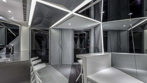 A modern office space with cubicles, a reception area, and a staircase. - Reality Design Inn (Tainan)