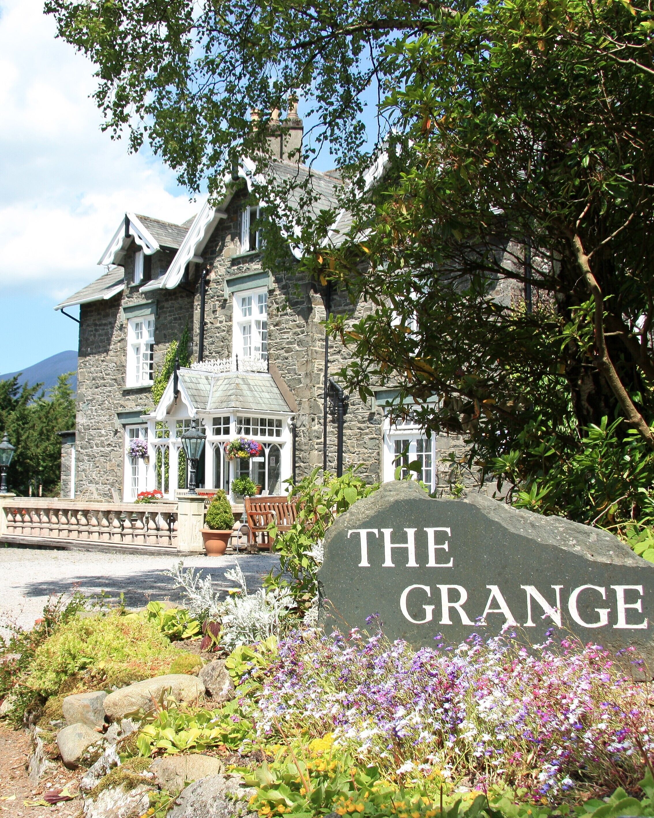A stone building with a sign reading "THE GRANGE".