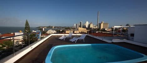 Outdoor pool, a rooftop pool, sun loungers