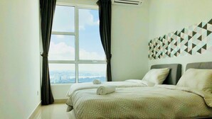 A hotel room with a large window, a bed with a patterned bedspread, and a geometric wall decoration. - Pinnacle Tower Johor Bahru (Johor Bahru)