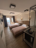 Standard Triple Room, Sea View | Minibar, in-room safe, desk, blackout drapes