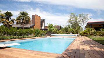 Relax by the pool surrounded by a wooden deck.