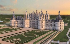 A large, historic building with multiple towers and a symmetrical garden layout. - Hôtel du Chateau (Tour-en-Sologne)