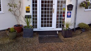 A reception area with a sign reading "RECEPTION" above the door, a "AA Guest House" sign, and a "Post" sign.