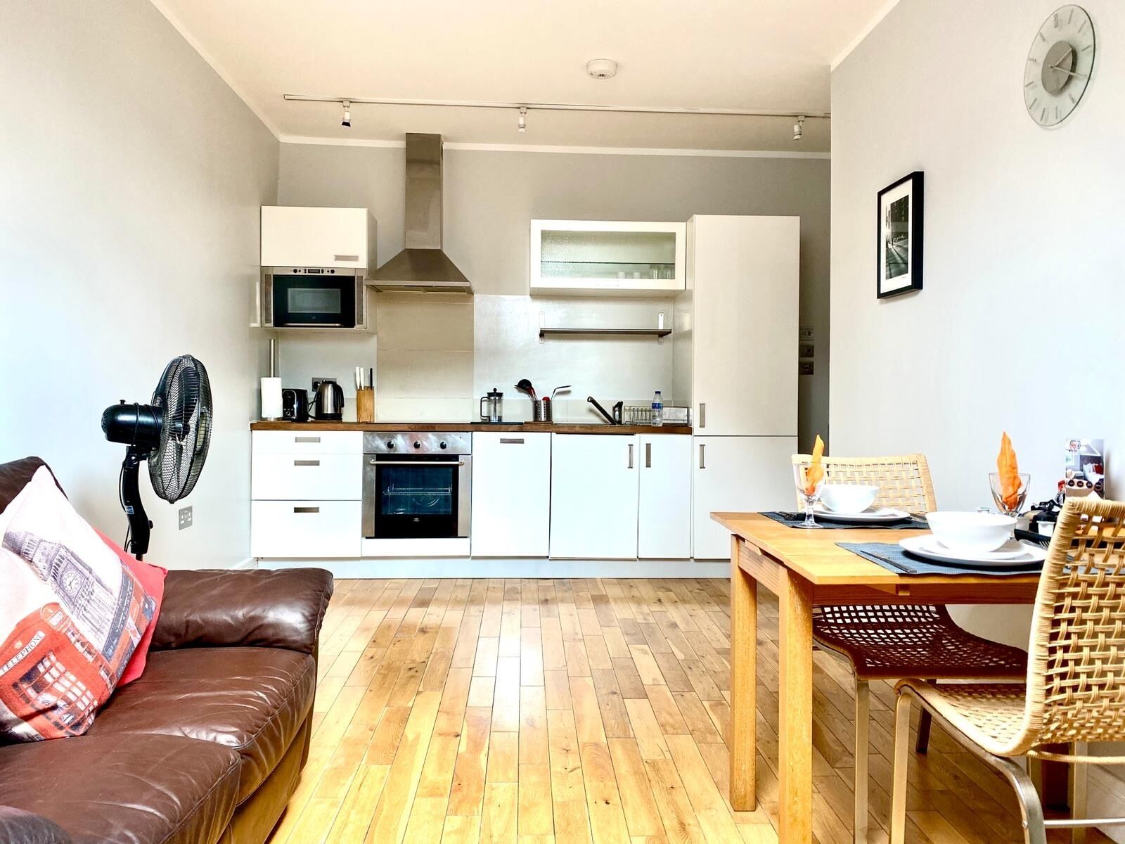 A compact living space with a kitchenette, a dining area, and a seating area.