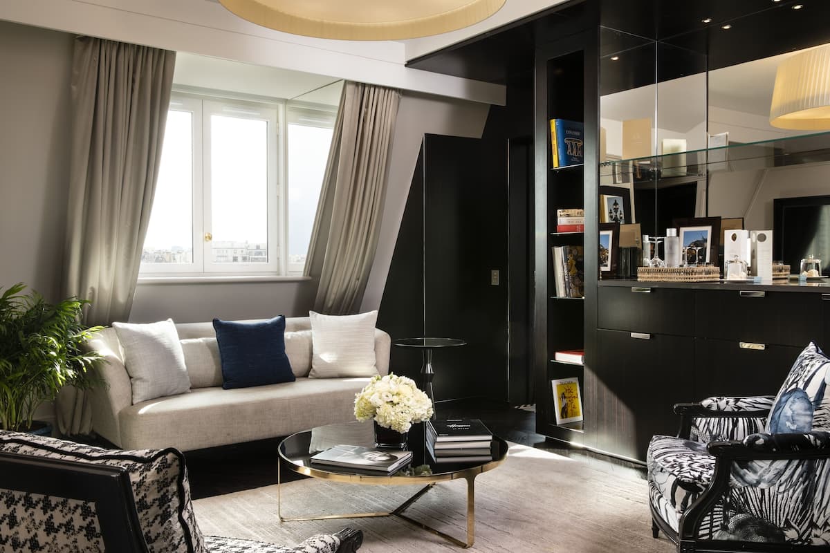 A modern living room with a sofa, coffee table, and a bookshelf.