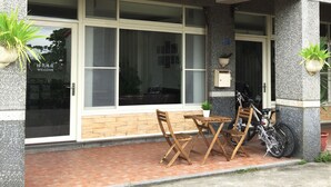 A hotel entrance with a signboard displaying contact information. - Migratory Birds Hotel (Toucheng)