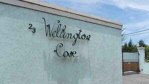 A building with a sign that reads "23 Wellington Care". - Wellington Cove (Kingston)