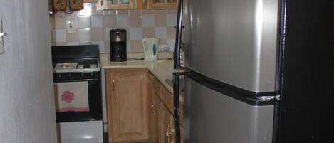 Full-size fridge, microwave, stovetop, coffee/tea maker