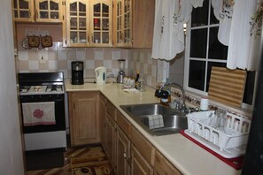 Full-size fridge, microwave, stovetop, coffee/tea maker