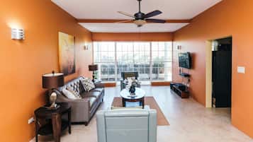 Family Apartment, 2 Bedrooms, Beach View, Beachfront | Living area | Flat-screen TV