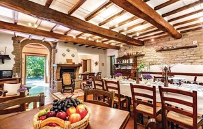 Enjoy dining in this charming space with a large wooden table and comfortable seating.