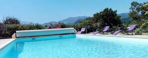 A swimming pool with a view of mountains in the background.