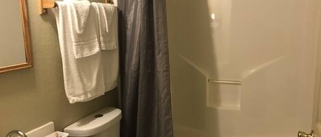 A bathroom with a toilet, sink, and bathtub.
