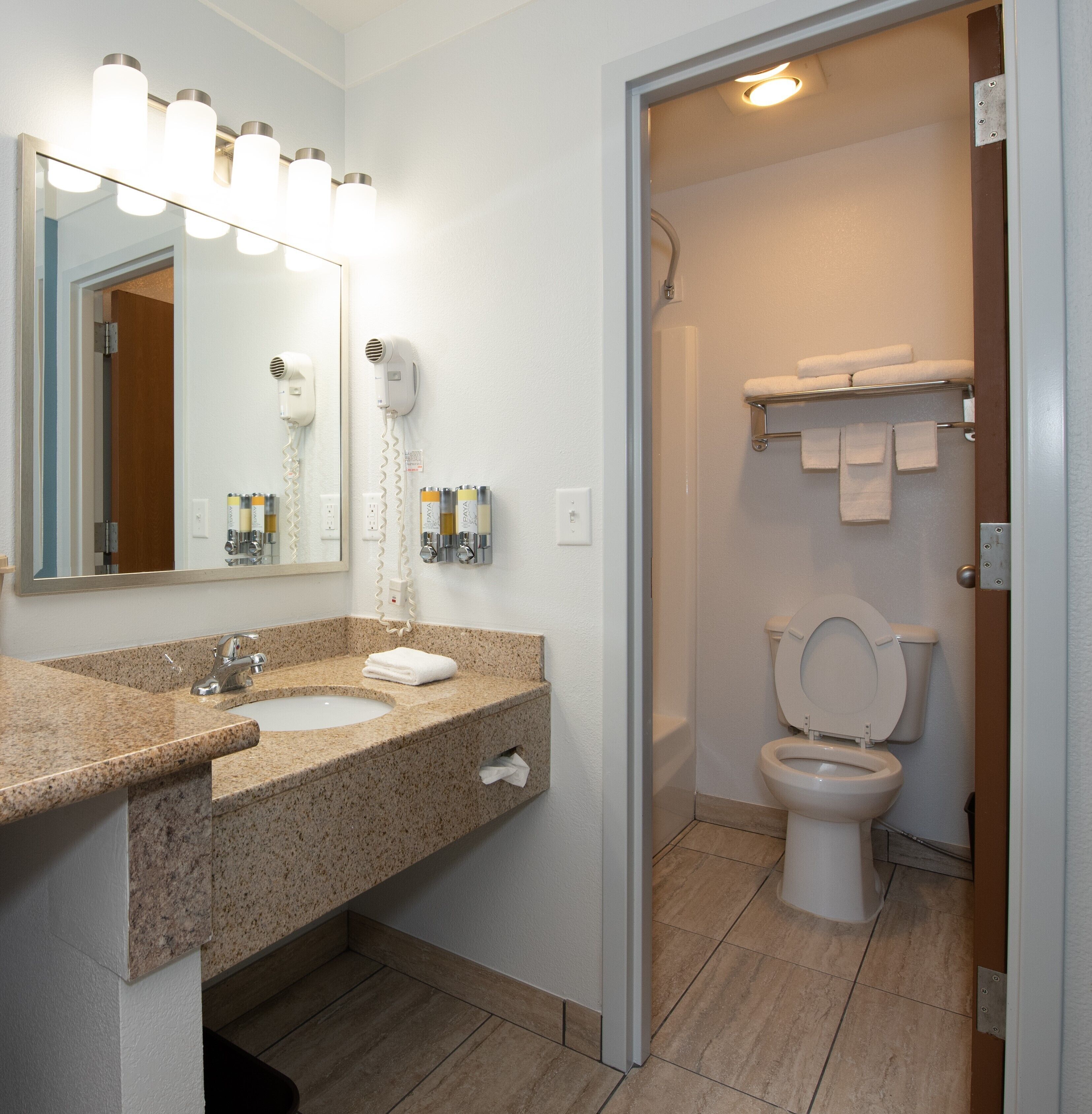 combined shower/bathtub, designer toiletries, hair dryer, towels