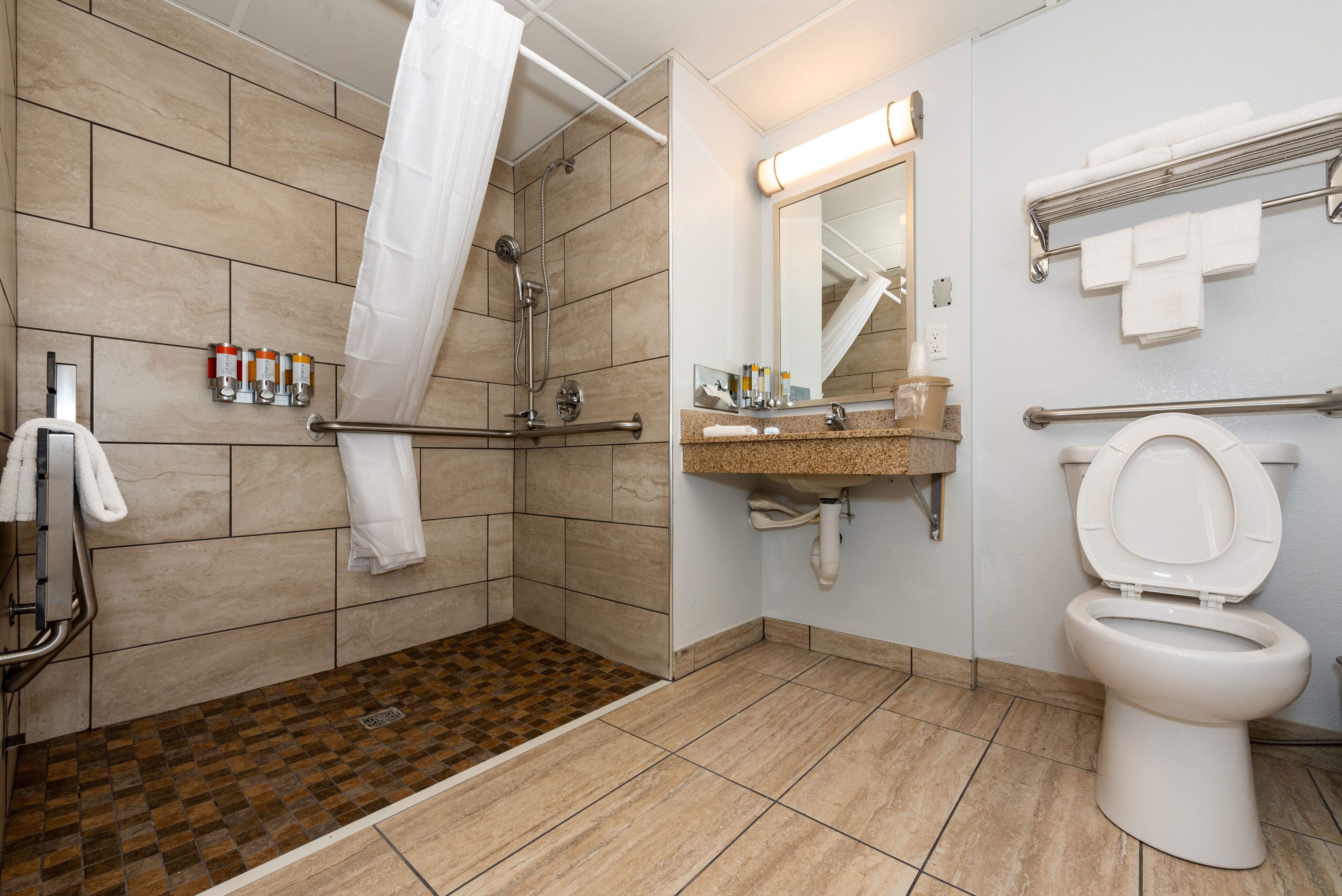 room, 2 queen beds, pet friendly, roll-in shower | bathroom | combined shower/bathtub, designer toiletries, hair dryer, towels