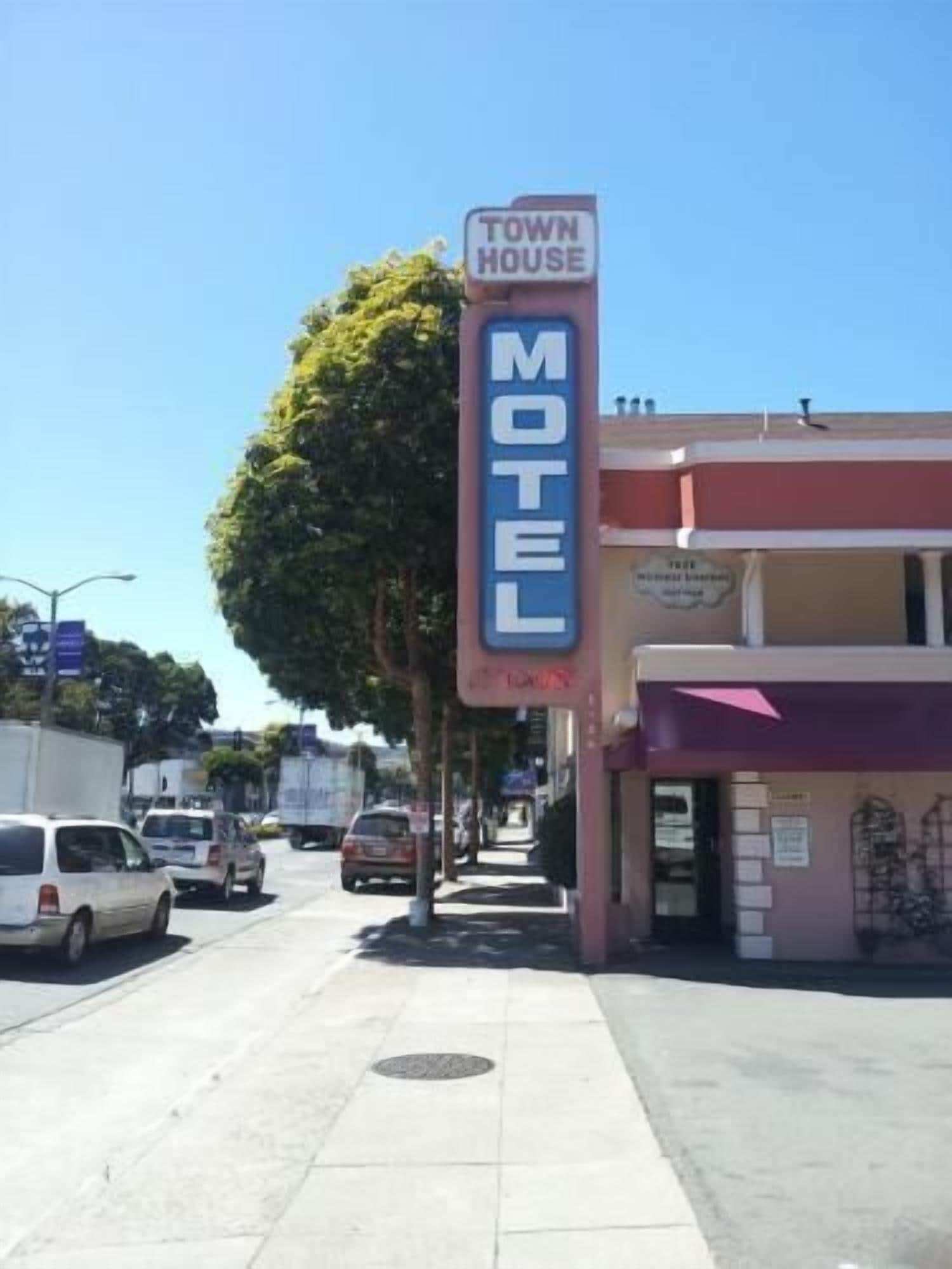 A motel sign with 'TOWN HOUSE' and 'MOTEL' written on it.
