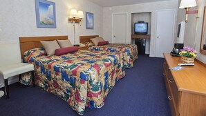 A hotel room with two beds, a desk, a television, and a bathroom door. - Townhouse Motel (San Francisco)