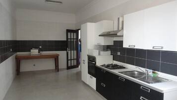 Apartment, 4 Bedrooms | Private kitchen | Fridge, microwave, oven, cookware/dishes/utensils