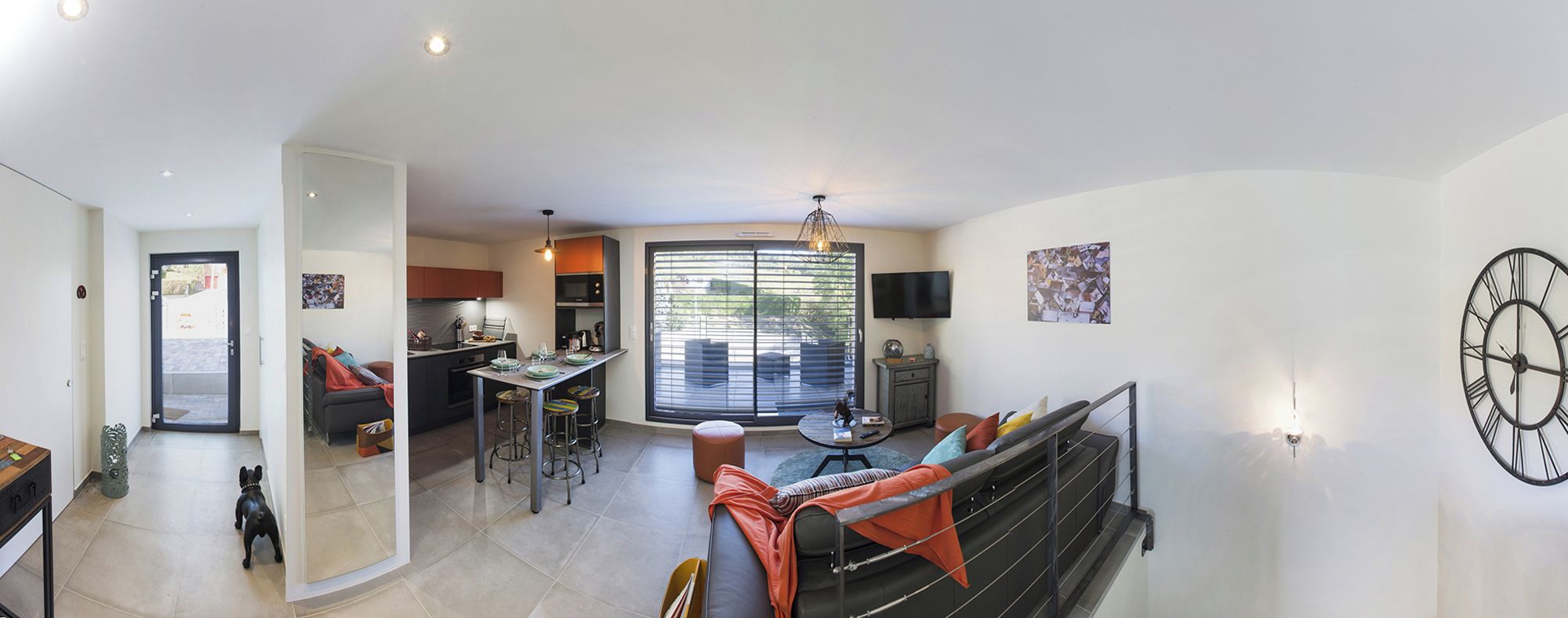 A modern interior with a kitchen, dining area, and living space.