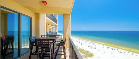 A balcony with a view of a beach and ocean.