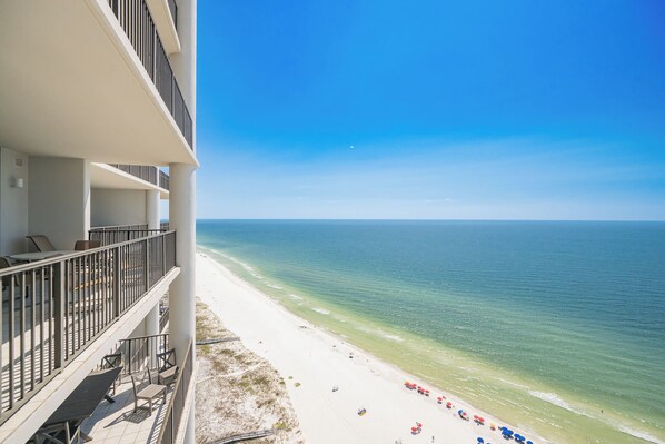 A beachfront hotel with balconies overlooking the ocean.