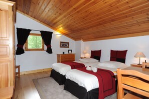 A bedroom with two beds, wooden ceiling, a window with curtains, a nightstand, a lamp, and a framed picture on the wall. - Superb duplex in luxury apartment at foot of slopes (Val-D'isère)
