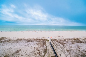 A beach with a sandy shore, a clear sky, and a calm sea. - 7th Floor! Two Bedroom - Balcony on the Beach! Phoenix X (Orange Beach)