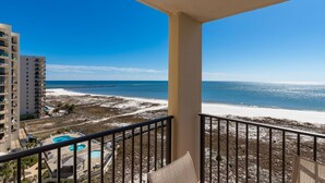 A balcony with a view of a beach and a pool. - 9th Floor One Bedroom ~ XTRA HALF BATH! Phoenix VII (Orange Beach)