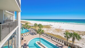 A resort balcony with a view of a beach and a swimming pool. - The Oasis at Orange Beach, formerly known as Phoenix West II, Unit 303 (Orange Beach)