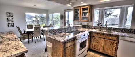 Enjoy cooking in this well-equipped kitchen with a central island, stovetop and oven, and dining area.
