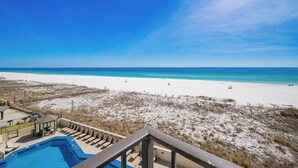 A beach view from a balcony with a pool and lounge chairs. - SAVE MORE! ~ 2 Bedroom ~ Phoenix III (Orange Beach)