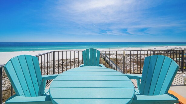 A view from a deck with two turquoise Adirondack chairs facing a beach. - SAVE MORE! ~ 2 Bedroom ~ Phoenix III (Orange Beach)