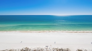 A beach with clear turquoise water and white sand.