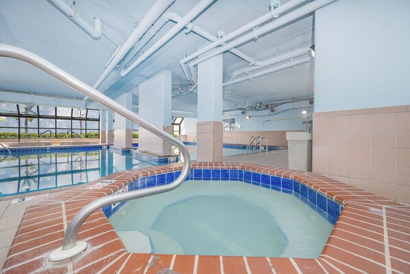 Soak in the hot tub and unwind with a refreshing view of the beach front on your next beach vacation at Phoenix V