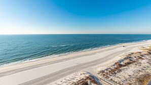 A beach with a clear view of the ocean and a sandy path leading to the water. - The Gulf, the Sun, the View 2 bedroom Phoenix X 1216 (Orange Beach)