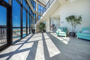 Relax in this stylish space with a mezzanine level, light-colored tiles, and a comfortable sofa.