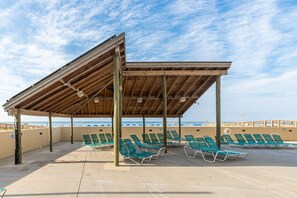 Relax in comfort on the beachside pavilion, equipped with lounge chairs for a leisurely stay.