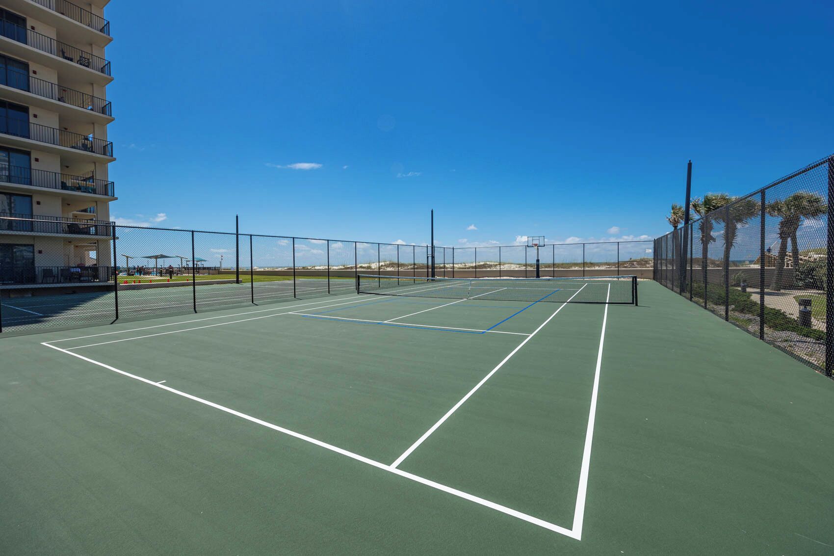 Stay fit with a pickleball or tennis game on the court with stunning views just steps away from your beachfront getaway