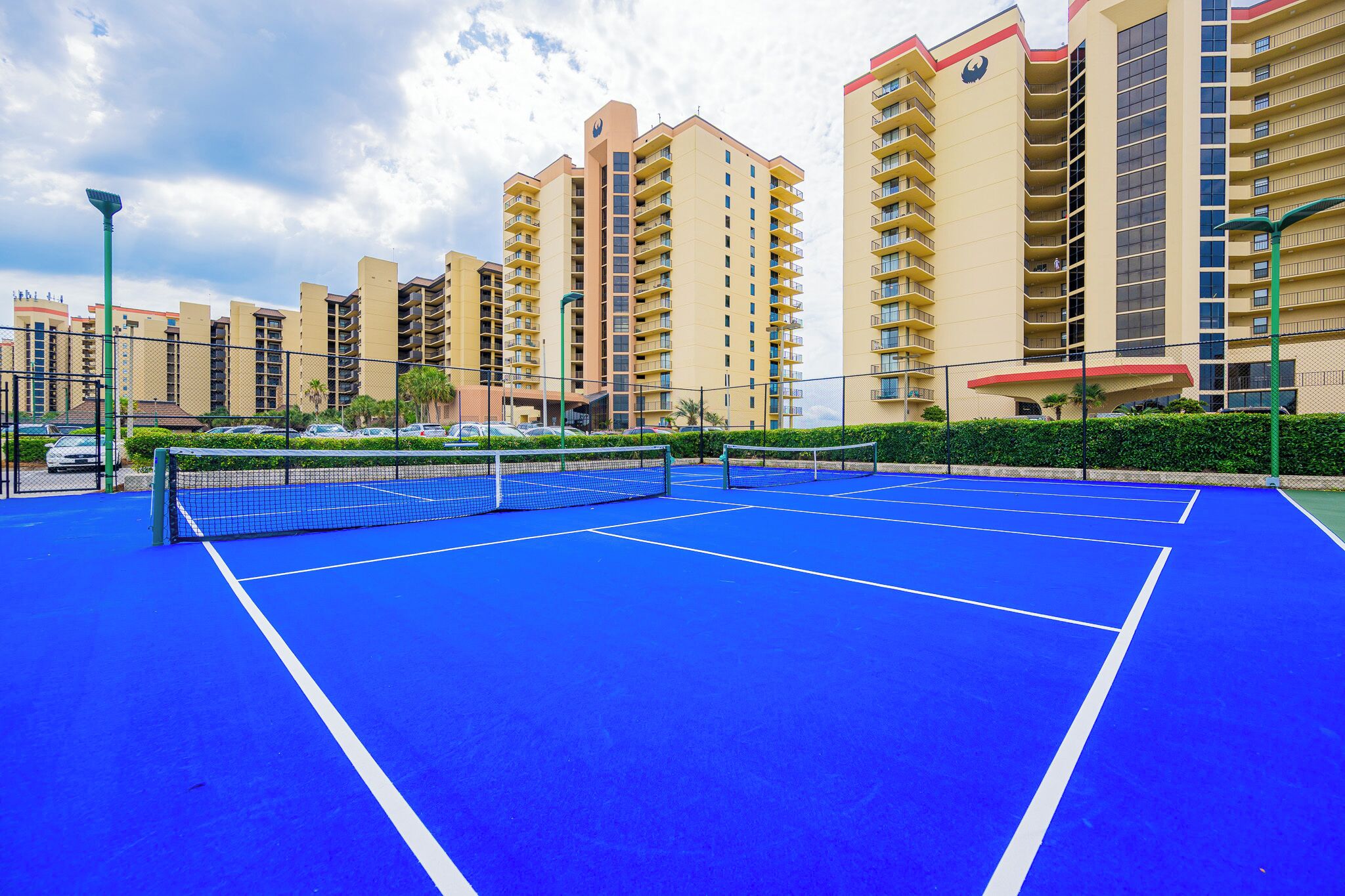 Play a game of pickleball on the courts at Phoenix III in Orange Beach surrounded by coastal landscaping and beach vibes