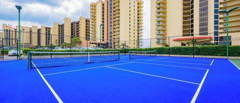 Play a game of pickleball on the courts at Phoenix III in Orange Beach surrounded by coastal landscaping and beach vibes
