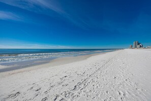 Enjoy a serene beach experience with gentle waves lapping at the shore.