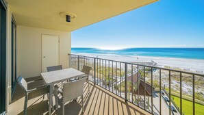 A balcony with a table and chairs overlooking a beach. - Phoenix 1 - Two Bedroom - Balcony on the Beach! (Orange Beach)