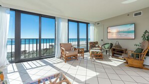 A spacious balcony with a view of the beach, furnished with wicker chairs and a glass table. - **WEEKLY SPECIALS!** Phoenix III - Low Floor - 2 Bedroom (Orange Beach)